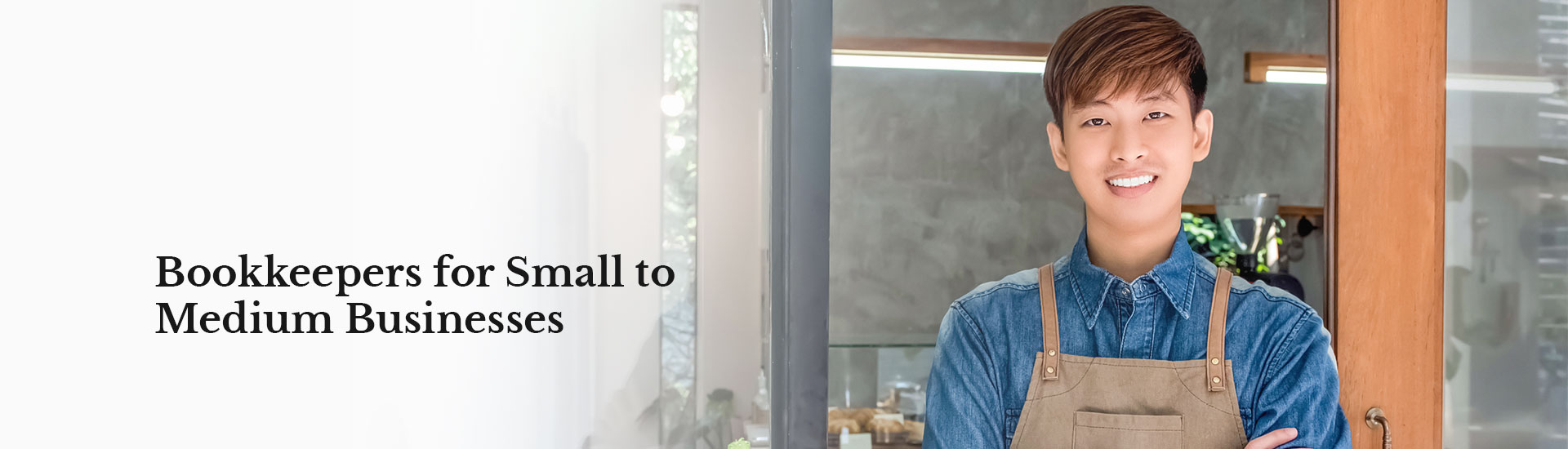 Owner of a cafe standing at the open door smiling